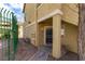 Exterior view of the tan-colored condo featuring desert landscaping and a fenced walkway at 1560 Jamielinn Ln # 101, Las Vegas, NV 89110