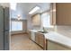 Bright kitchen featuring tile floors, white countertops and cabinetry, with an open dining area at 1560 Jamielinn Ln # 101, Las Vegas, NV 89110