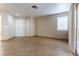 Living room featuring tile floors and ample space, with a double door and access to the balcony at 1560 Jamielinn Ln # 101, Las Vegas, NV 89110