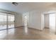 Living room featuring tile floors, access to the balcony, and an arched entryway to the kitchen at 1560 Jamielinn Ln # 101, Las Vegas, NV 89110