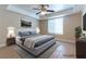 Comfortable main bedroom features a ceiling fan, natural lighting, and neutral decor at 1560 Jamielinn Ln # 101, Las Vegas, NV 89110