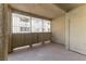 Neutral tiled patio with textured walls and a metal framed exterior view at 1560 Jamielinn Ln # 101, Las Vegas, NV 89110