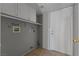 Cozy laundry room with overhead cabinets, a hanging rod, washer/dryer hookups, and access door at 1903 Ginger Blossom Ave, North Las Vegas, NV 89031