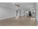 Open-concept living area featuring tile flooring, a ceiling fan, neutral walls, and eat-in kitchen at 1903 Ginger Blossom Ave, North Las Vegas, NV 89031