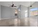 Bright living room features vaulted ceilings, many windows, decorative ceiling fans, and neutral tile flooring at 1903 Ginger Blossom Ave, North Las Vegas, NV 89031