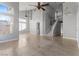 Spacious living room featuring stairs to the second floor, soaring ceilings, and neutral tile floors at 1903 Ginger Blossom Ave, North Las Vegas, NV 89031