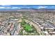 Wide aerial view of the community with a large park, nearby school, and scenic mountain backdrop at 1909 Mountain Hills Ct # 103, Las Vegas, NV 89128