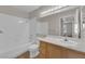 Well-lit bathroom featuring a tub-shower combo and a wooden vanity with a white countertop at 1909 Mountain Hills Ct # 103, Las Vegas, NV 89128