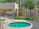 Community hot tub with clear blue water and relaxing lounge chairs in a serene setting at 1909 Mountain Hills Ct # 103, Las Vegas, NV 89128