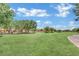 Expansive grassy area in the community park, perfect for recreation and relaxation under the blue sky at 1909 Mountain Hills Ct # 103, Las Vegas, NV 89128