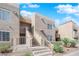 Inviting condo building exterior with well-maintained landscaping and visible stairway access at 1909 Mountain Hills Ct # 103, Las Vegas, NV 89128