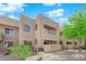 Exterior view of a condo building showing balconies and desert-friendly landscaping at 1909 Mountain Hills Ct # 103, Las Vegas, NV 89128