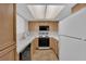 Kitchen featuring white fridge, wooden cabinets, and standard appliances at 1909 Mountain Hills Ct # 103, Las Vegas, NV 89128