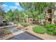 Well-kept landscaping with mature trees and manicured bushes along a walkway at 1909 Mountain Hills Ct # 103, Las Vegas, NV 89128