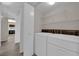 Functional laundry area with washer, dryer, and shelving for storage at 1909 Mountain Hills Ct # 103, Las Vegas, NV 89128