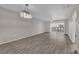Spacious living room with hardwood floors, stylish lighting fixture, and sliding glass doors at 1909 Mountain Hills Ct # 103, Las Vegas, NV 89128