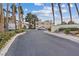 Community entrance with mature trees and complex signage at 2251 Wigwam Pkwy # 314, Henderson, NV 89074
