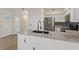 Bright kitchen features stainless appliances, light gray cabinetry and granite countertops at 2251 Wigwam Pkwy # 314, Henderson, NV 89074