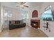 Cozy living room featuring a brick fireplace, a comfortable sofa, and ample natural light at 2251 Wigwam Pkwy # 314, Henderson, NV 89074