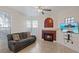 Inviting living room with fireplace, fan, and windows letting in natural light at 2251 Wigwam Pkwy # 314, Henderson, NV 89074