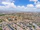 Extensive aerial capture of a neighborhood with patterned roofs, set against a backdrop of desert terrain and distant mountain peaks at 2833 Athena Hill Ct, Henderson, NV 89052