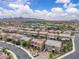 Picturesque aerial view of a neighborhood, highlighting the well-spaced homes and scenic mountain backdrop at 2833 Athena Hill Ct, Henderson, NV 89052