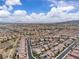 Panoramic view of a densely populated suburban area extending to the horizon, dotted with trees and mountains in the distance at 2833 Athena Hill Ct, Henderson, NV 89052
