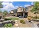 Backyard with covered patio, artificial turf, decorative landscaping, and gravel at 2833 Athena Hill Ct, Henderson, NV 89052
