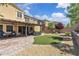 Backyard with covered patio, built-in seating, landscaping and artificial turf at 2833 Athena Hill Ct, Henderson, NV 89052