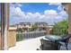 Inviting balcony featuring stylish patio furniture and views of neighboring homes under a partly cloudy sky at 2833 Athena Hill Ct, Henderson, NV 89052