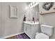 Neutral half bathroom featuring a single sink vanity and decorative wall art at 2833 Athena Hill Ct, Henderson, NV 89052