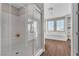 Bathroom showcasing a walk-in glass shower and soaking tub under large windows at 2833 Athena Hill Ct, Henderson, NV 89052
