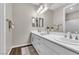 Bright bathroom with double sinks and vanities, featuring chrome fixtures and white cabinets at 2833 Athena Hill Ct, Henderson, NV 89052