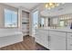 Bathroom with a soaking tub, built in shelves and a double vanity with gold fixtures at 2833 Athena Hill Ct, Henderson, NV 89052