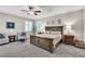 Comfortable bedroom featuring a king-size bed, ceiling fan, and natural light from the windows at 2833 Athena Hill Ct, Henderson, NV 89052
