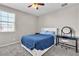 Bright bedroom with carpet, ceiling fan, and window, featuring a desk and decor at 2833 Athena Hill Ct, Henderson, NV 89052