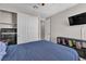 Comfortable bedroom with closet, television, and decorative bedside storage at 2833 Athena Hill Ct, Henderson, NV 89052
