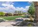 Scenic neighborhood park with a large grassy area, mature shade trees, and inviting seating at 2833 Athena Hill Ct, Henderson, NV 89052