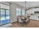 Cozy dining area with backyard access and contemporary chandelier at 2833 Athena Hill Ct, Henderson, NV 89052