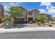 Two-story home with a brick driveway, desert landscaping and a small front balcony at 2833 Athena Hill Ct, Henderson, NV 89052