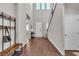 Inviting foyer with soaring ceilings, tile flooring, a coat rack, and staircase leading to the upper level at 2833 Athena Hill Ct, Henderson, NV 89052