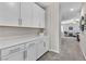Hallway with a line of cabinets and drawers and access to living room at 2833 Athena Hill Ct, Henderson, NV 89052
