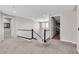 Second story landing with carpeted floors and black railings and white spindles at 2833 Athena Hill Ct, Henderson, NV 89052