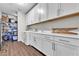 Well-organized laundry room with modern appliances, white cabinets, and a utility sink at 2833 Athena Hill Ct, Henderson, NV 89052