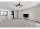 Large carpeted second living space with a ceiling fan and a built-in entertainment system at 2833 Athena Hill Ct, Henderson, NV 89052