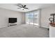 Bright living room with sliding glass doors opening to a balcony, ceiling fan and neutral carpet at 2833 Athena Hill Ct, Henderson, NV 89052