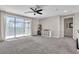 Spacious carpeted living room with sliding glass door to the outdoor terrace at 2833 Athena Hill Ct, Henderson, NV 89052