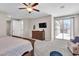 Expansive main bedroom with a balcony, tv, and ample space for relaxation and comfort at 2833 Athena Hill Ct, Henderson, NV 89052