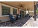 This covered patio features comfortable seating and a fan to help you relax at 2833 Athena Hill Ct, Henderson, NV 89052