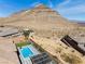 A home located at the base of the mountain featuring backyard with pool, spa, putting green, and outdoor kitchen at 3120 Greenscape Ln, Las Vegas, NV 89138